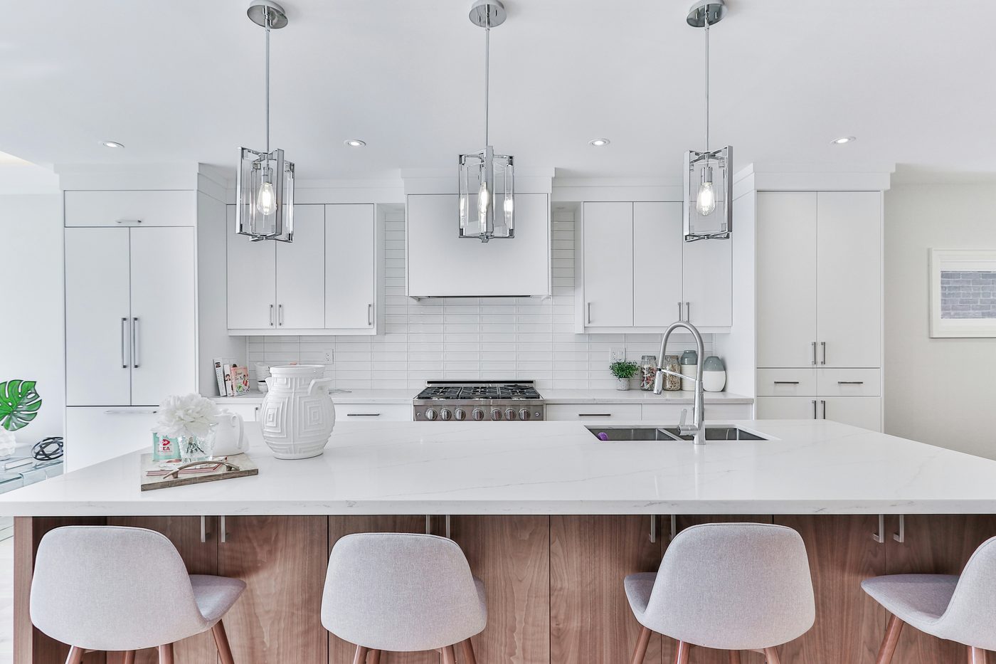 Bright white kitchen with pendant lighting over the island
